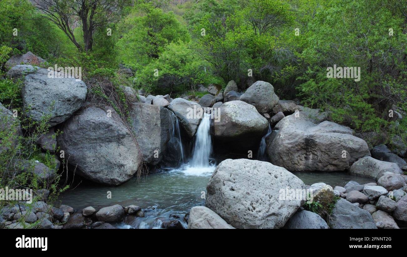 Beautiful view of a small waterfall among huge rocks Stock Photo - Alamy