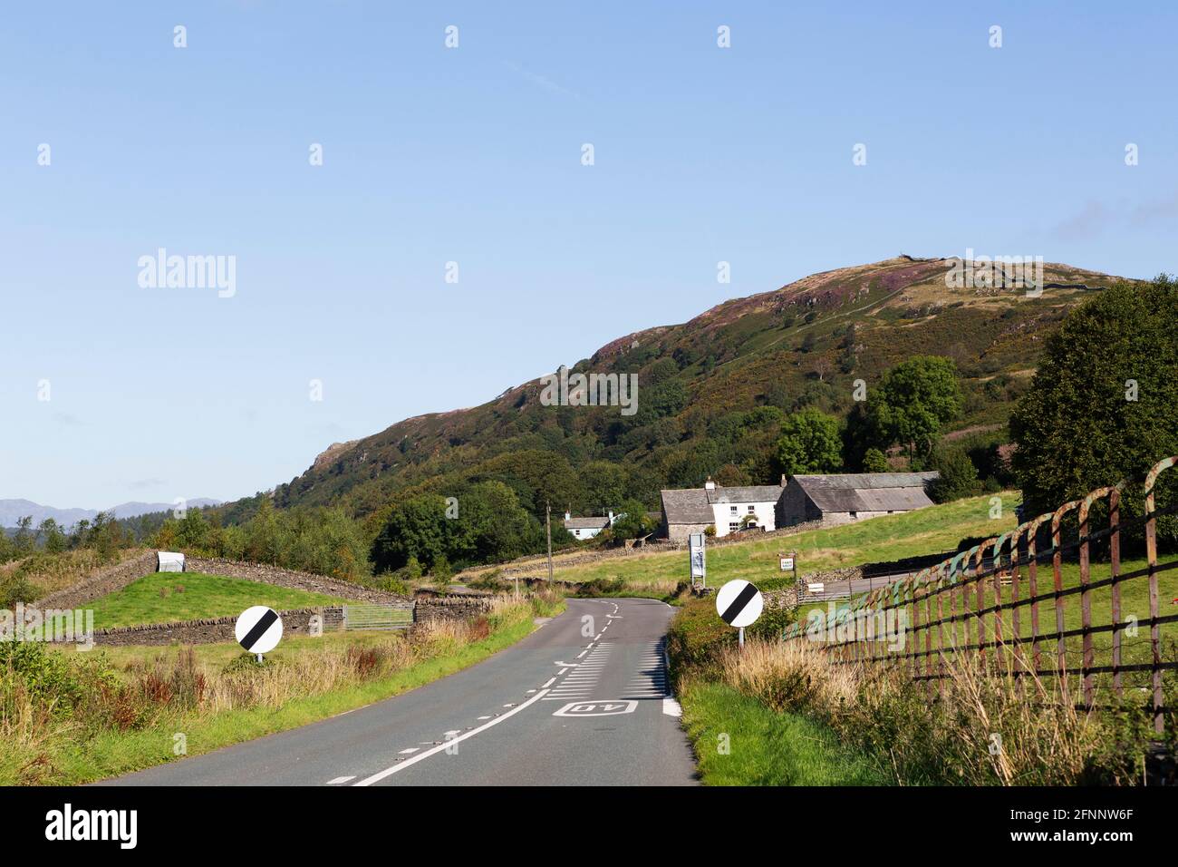 Country road near Newton in Cartmel in Cumbria, England. The tarmac road runs through the English Lake District. Stock Photo
