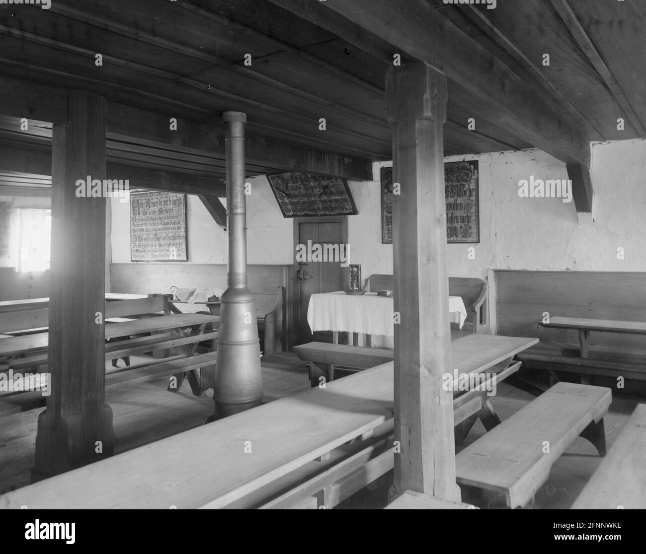 Ephrata Cloister, interior view of building showing meeting room or assembly hall with frakturs hanging on the walls, circa 1890 Stock Photo