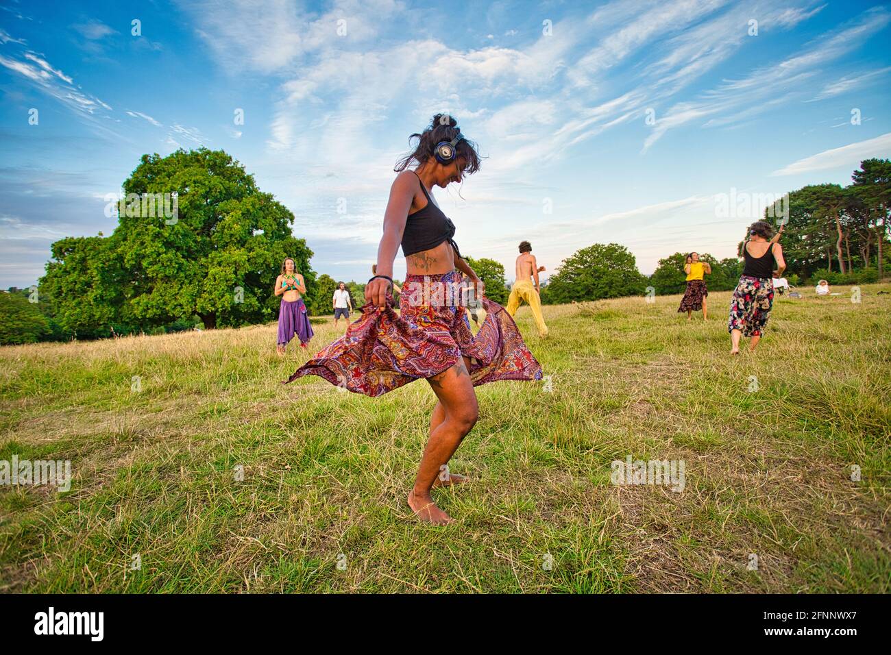 GREAT BRITAIN / England / London / Hampstead Heath / Ecstatic Dance London event . Dancers wearing wireless silent disco headphones. Stock Photo