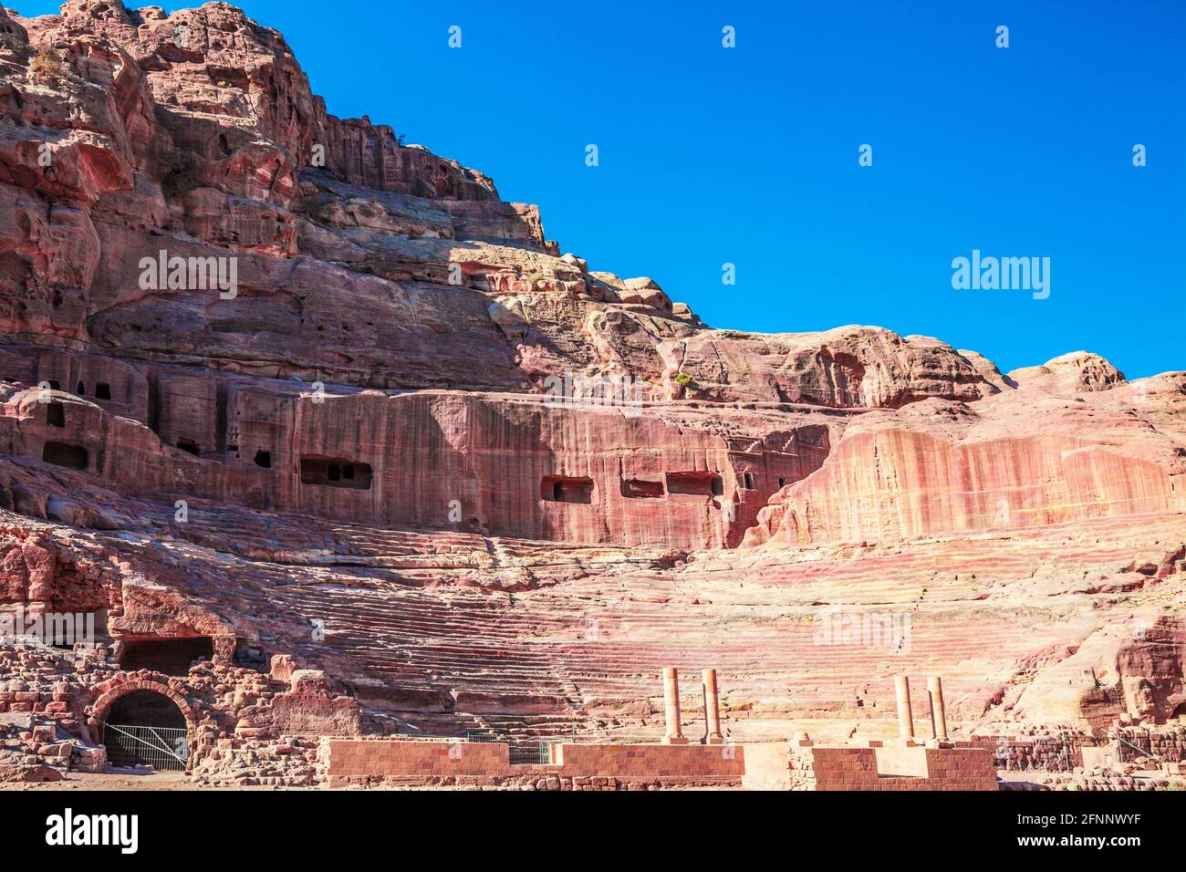 The theatre carved into the side of the Jabal al-Madhbah mountain in Petra, Jordan. Stock Photo