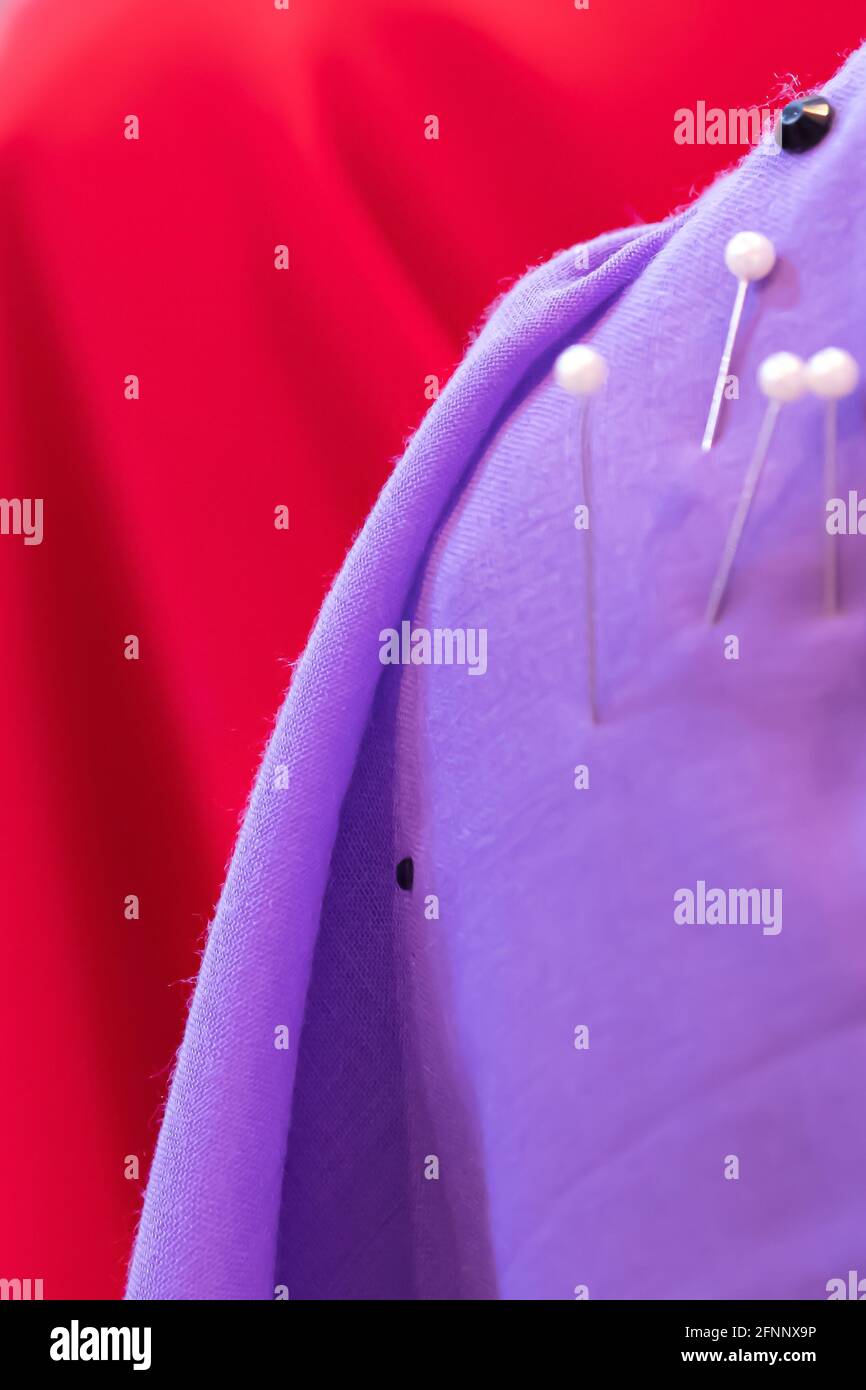 Closeup a mannequin in a fashion colours sewing pins lace to