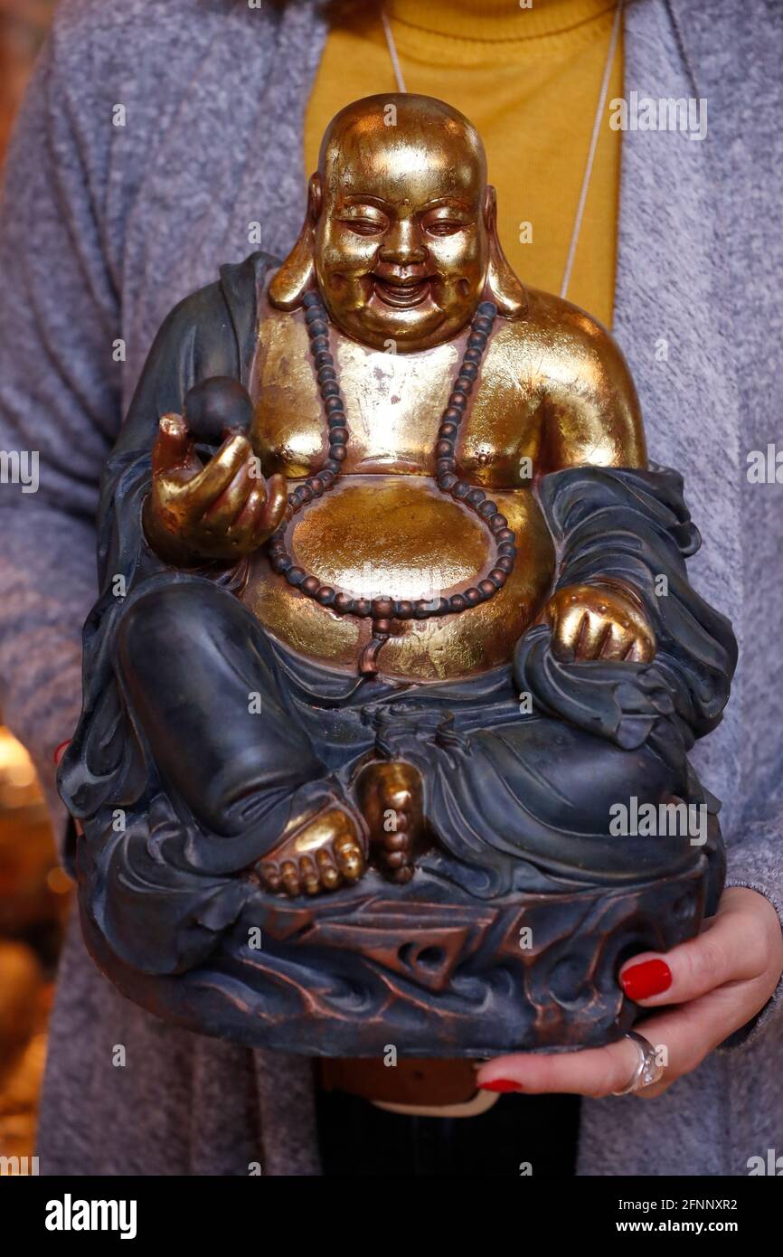 Tu An buddhist temple. Woman with laughing Buddha statue for health, wealth and prosperity