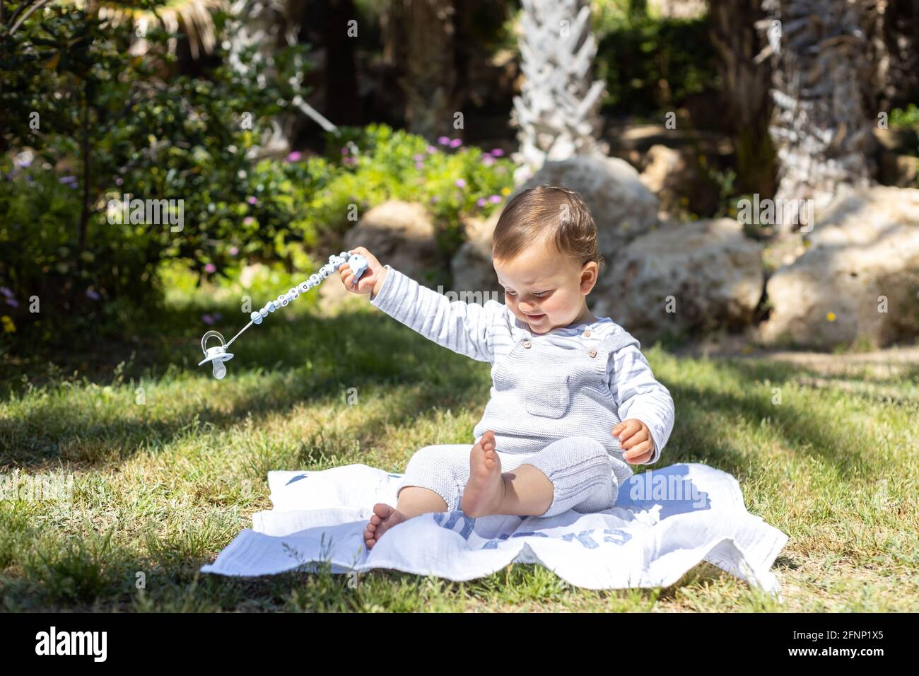 A young boy sitting on the grass. Stock Photo