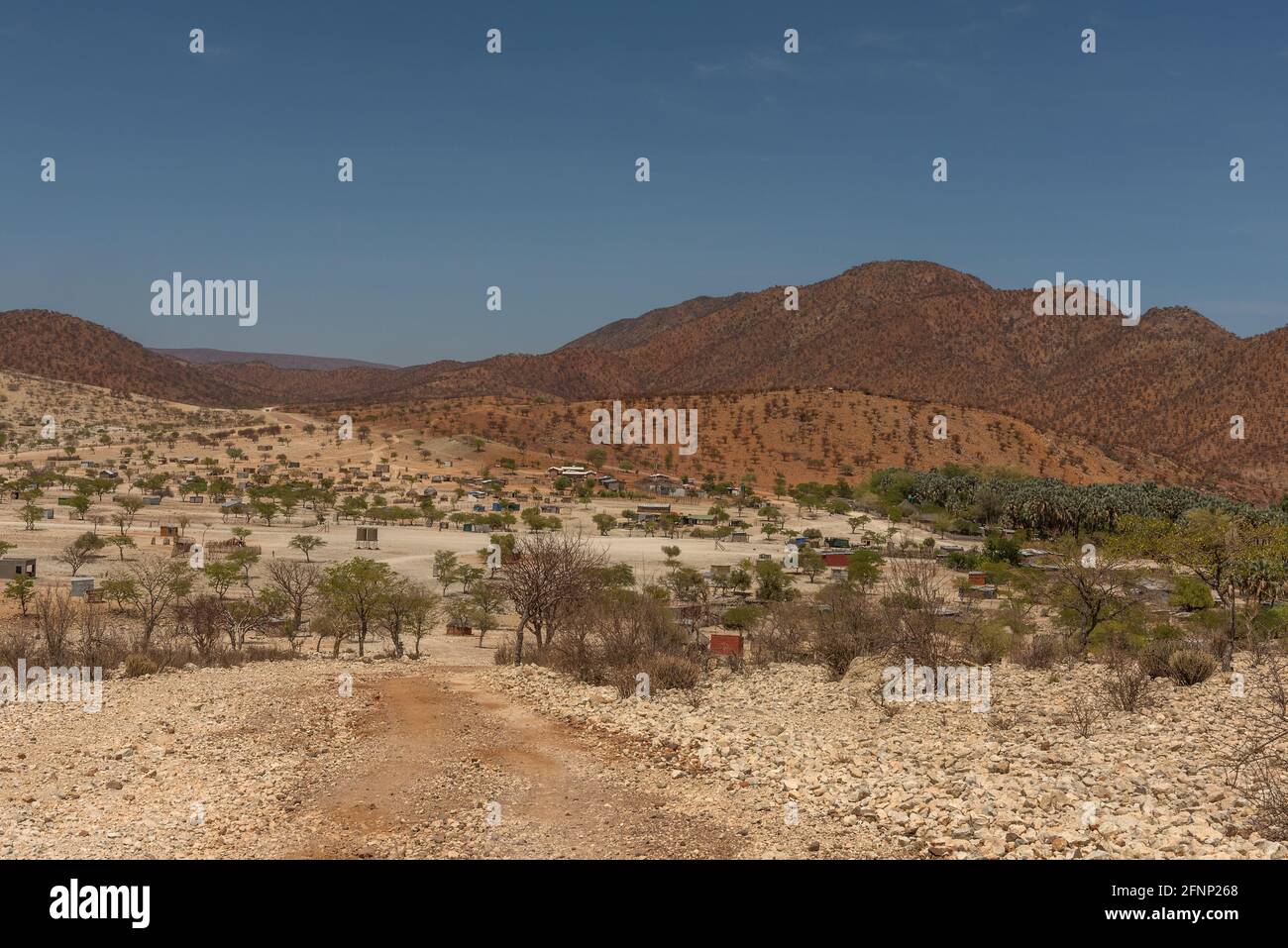 Landscape on the Kunene River with Himba village, Namibia Stock Photo