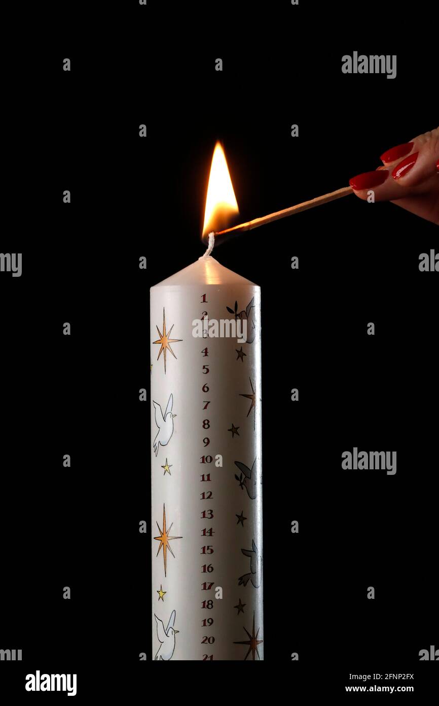 Woman lighting a christmas advent candle. France Stock Photo Alamy