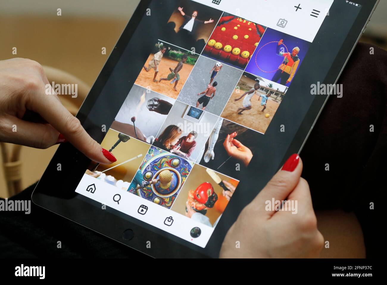 Woman reading  Instagram on an Apple iPad digital tablet.  Instagram social media app.  France. Stock Photo