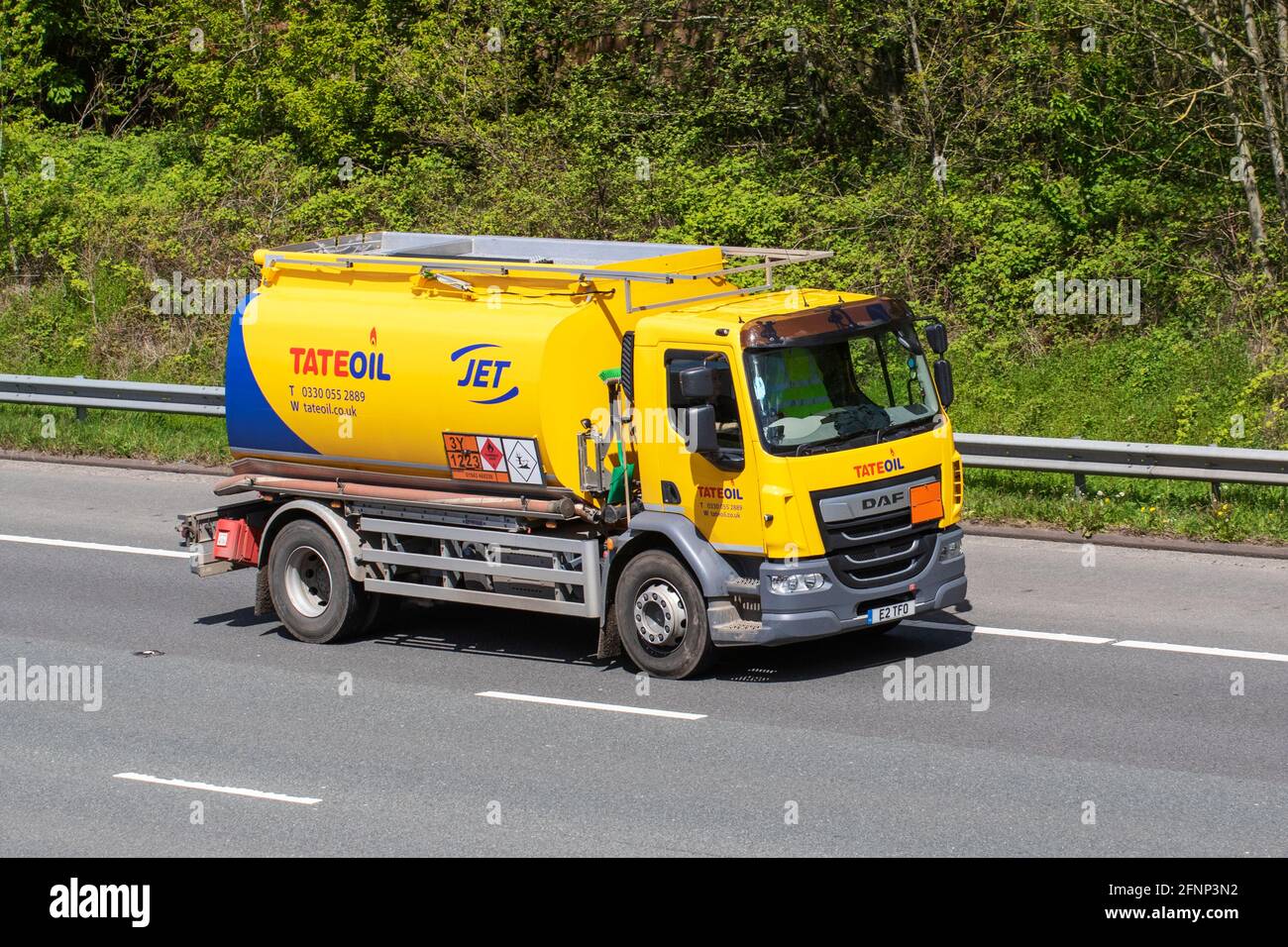 TATEOIL JET fuels tanker. 2021 Yellow Scania 9320 B 6x2*4 Diesel truck. TateOil Fuel Tanker; Bulk Haulage delivery trucks, haulage, lorry, transportation, truck, cargo, vehicle, domestic or commercial fuel delivery, transport industry, tank truck, gas truck, Tate oil Jet fuel truck, or tanker truck on the M6 at Lancaster, UK Stock Photo