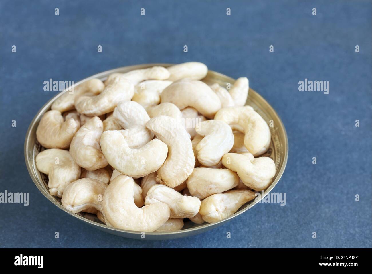 Cashew nuts in a bowl, selective focus. Stock Photo