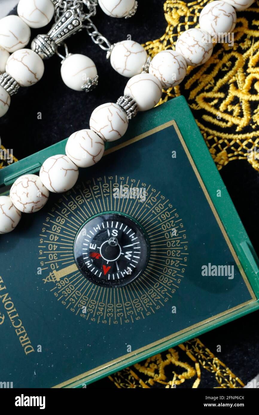 Quran, Qibla compass  and prayer beads ( misbaha ) . Symbols of Islam.  Dubai. United Arab Emirates Stock Photo