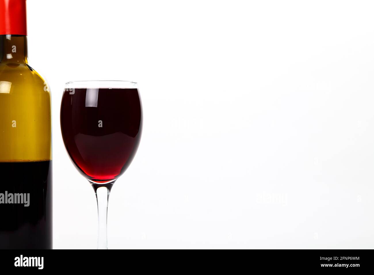Glass of red wine and a wine bottle with space for copy Stock Photo