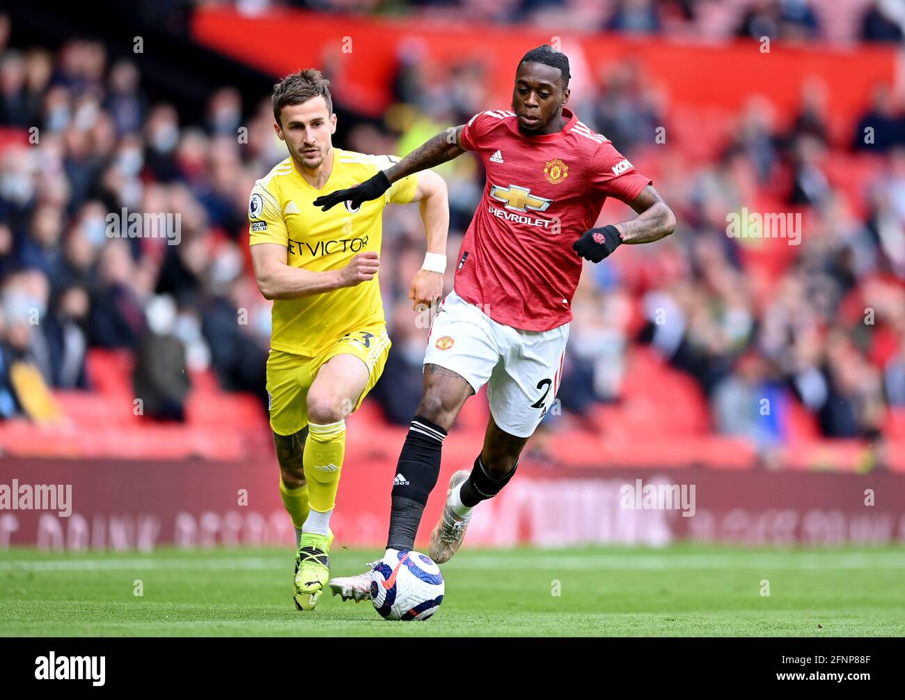 Fulham's Joe Bryan (left) and Manchester United's Aaron Wan-Bissaka battle for the ball during the Premier League match at Old Trafford, Manchester. Picture date: Tuesday May 18, 2021. Stock Photo