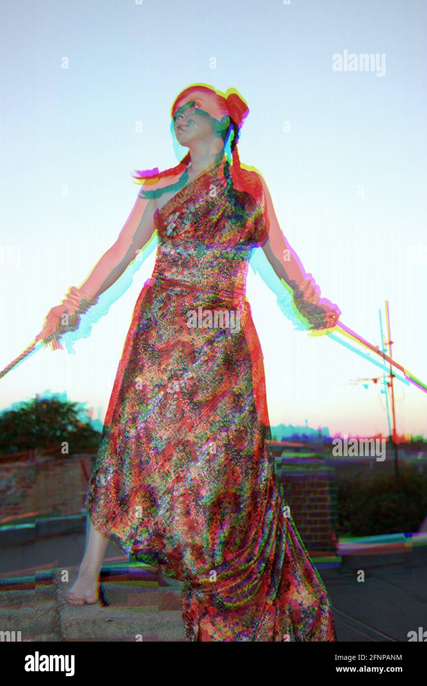 glitch effect of young woman in red dress being tied up with rope Stock Photo