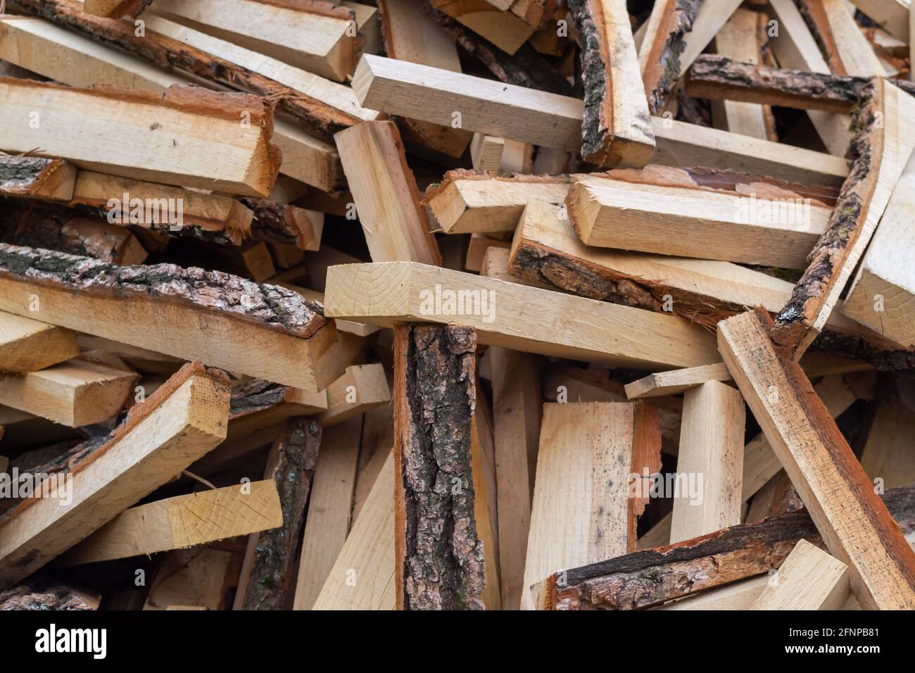 Dry chopped firewood in a bunch. Stack of firewood for kindling Stock