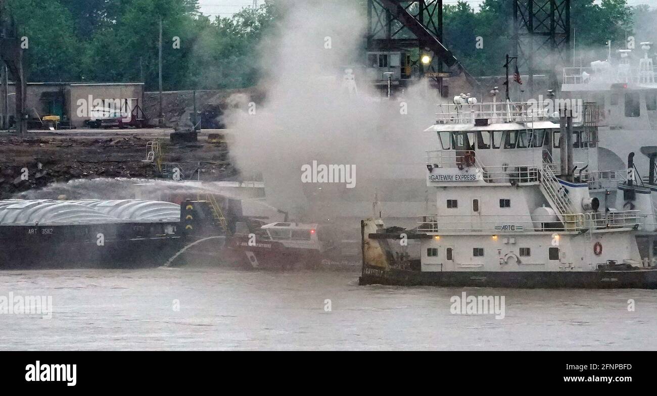 St. Louis, United States. 18th May, 2021. St. Louis firefighters aboard Marine Unit Six, battle a fire on the Mary Lynn tug boat on the Mississippi River south of the St. Louis riverfront in St. Louis on Tuesday, May 18, 2021. Firefighters were able to save the vessel after a fire broke out in the engine room, spreading to the rest of the boat.Two firefighters left the scene with smoke inhalation. Photo by Bill Greenblatt/UPI Credit: UPI/Alamy Live News Stock Photo