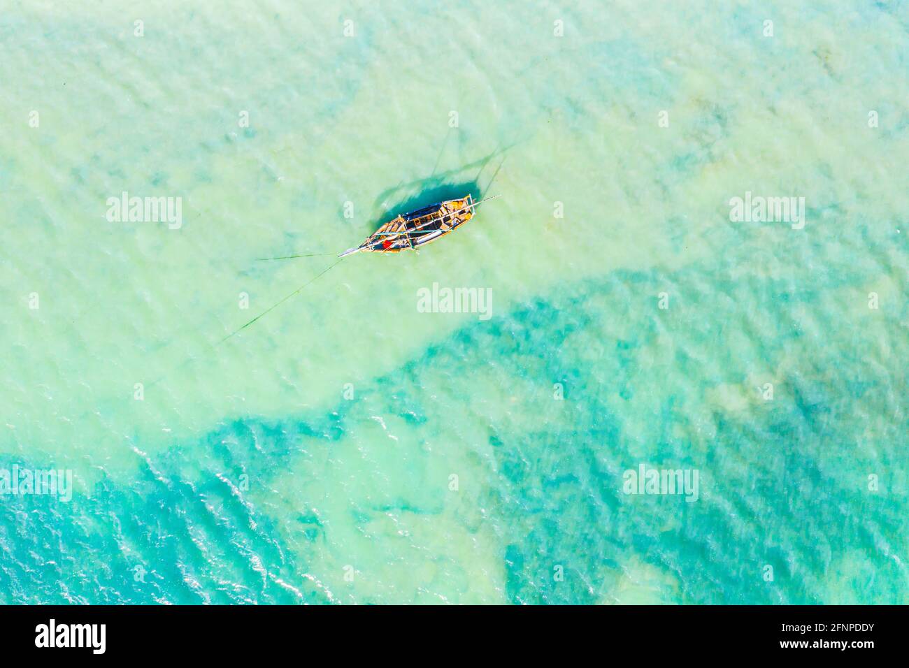 Aerial view of the fishing boats in clear blue water at sunny day in ...
