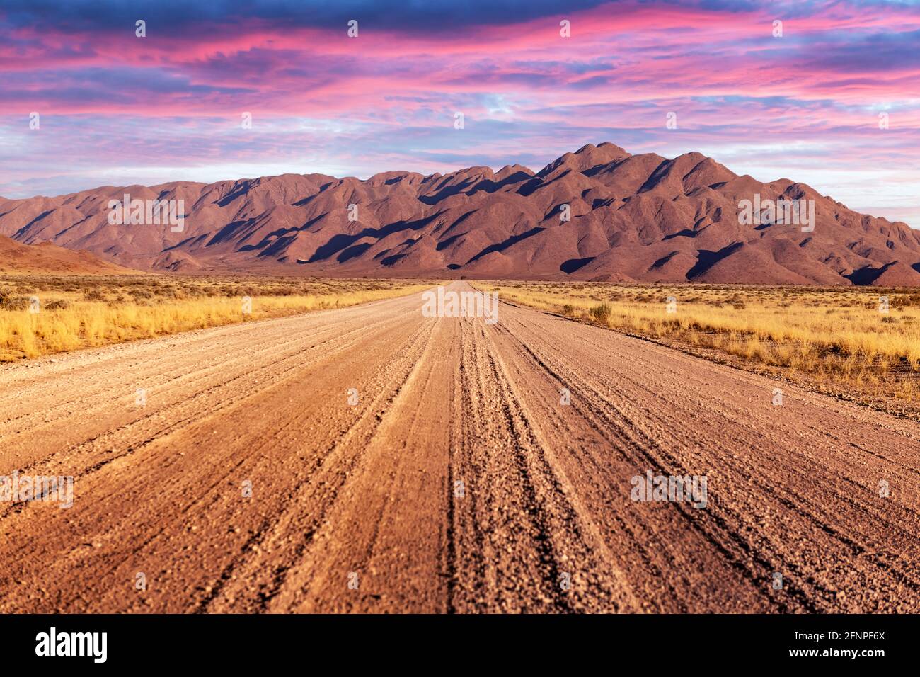 Gravel road and beautiful landscape with sunset sky Stock Photo