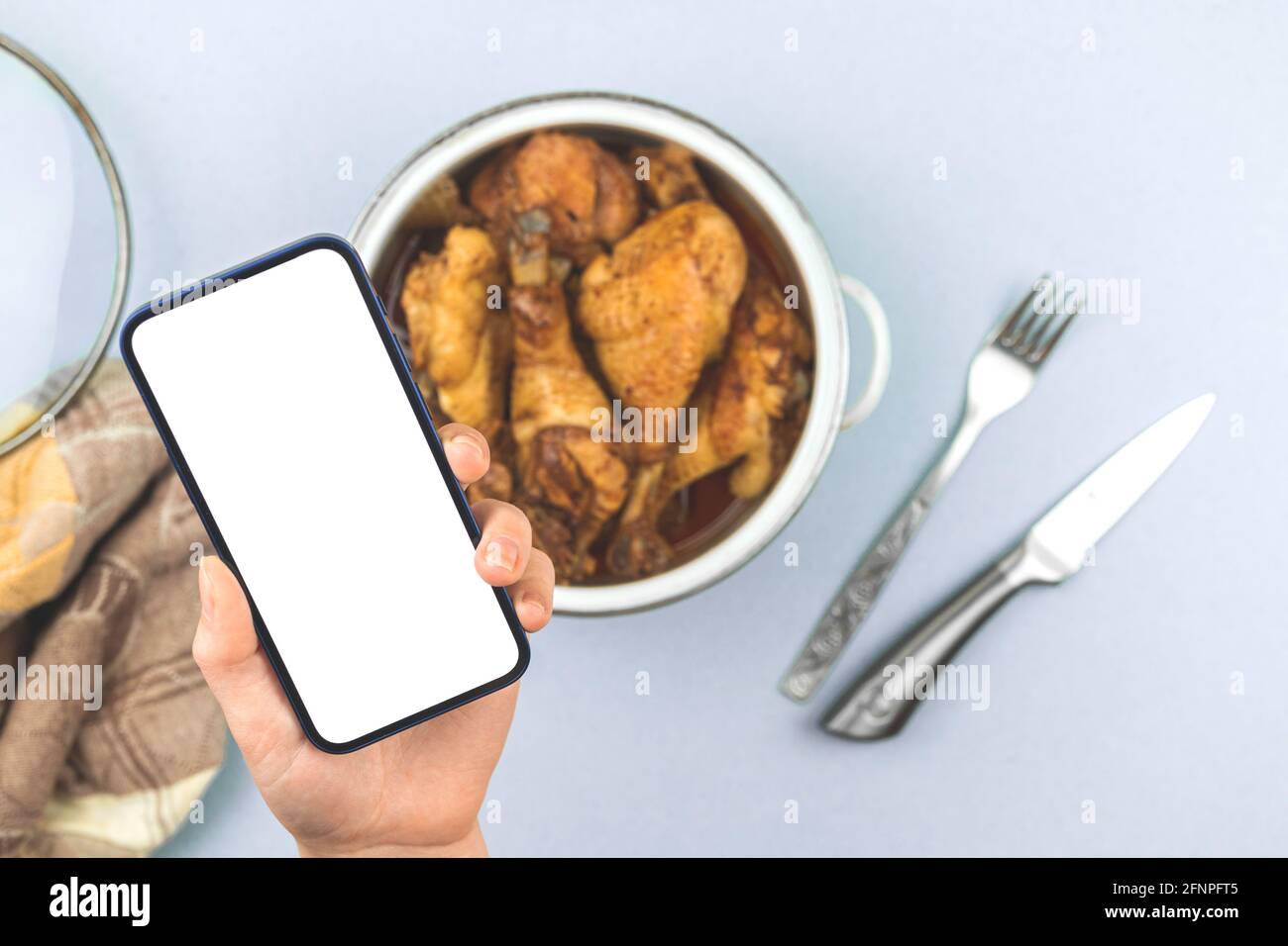 Download Woman Holds Mobile Phone With Mockup Screen With Roasted Food Home Fried Chicken In A Saucepan Healthy Food Menu For Restaurant Concept Photo White Stock Photo Alamy