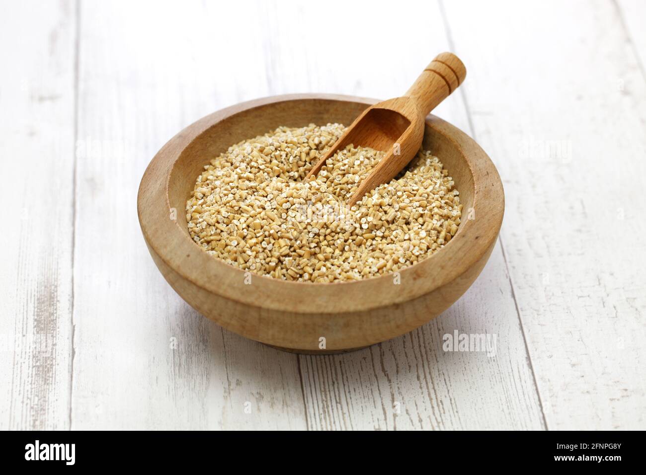 steel cut oats in wooden bowl Stock Photo
