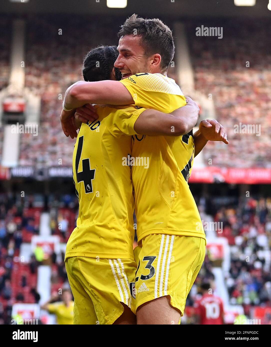 Fulham's Joe Bryan (right) celebrates scoring their side's first goal of the game during the Premier League match at Old Trafford, Manchester. Picture date: Tuesday May 18, 2021. Stock Photo