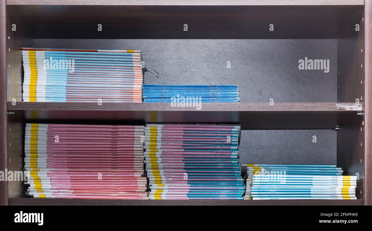 Bookshelf with textbooks and notebooks neatly arranged on the shelf