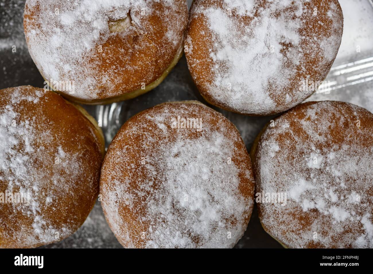 Chocolate or jelly filled donuts sprinkled with powder sugar Stock