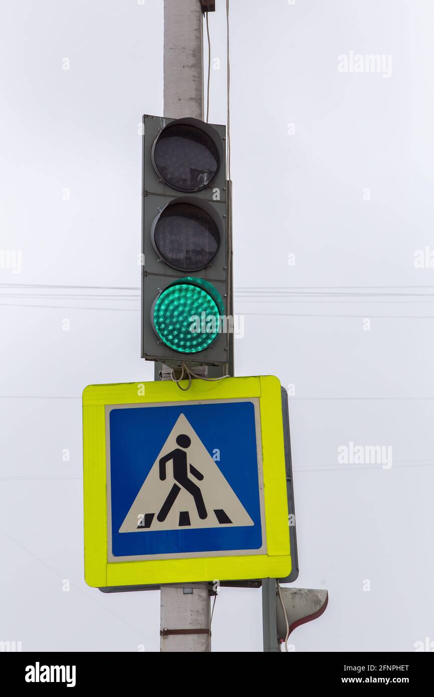 The green traffic light and the pedestrian crossing sign are on ...