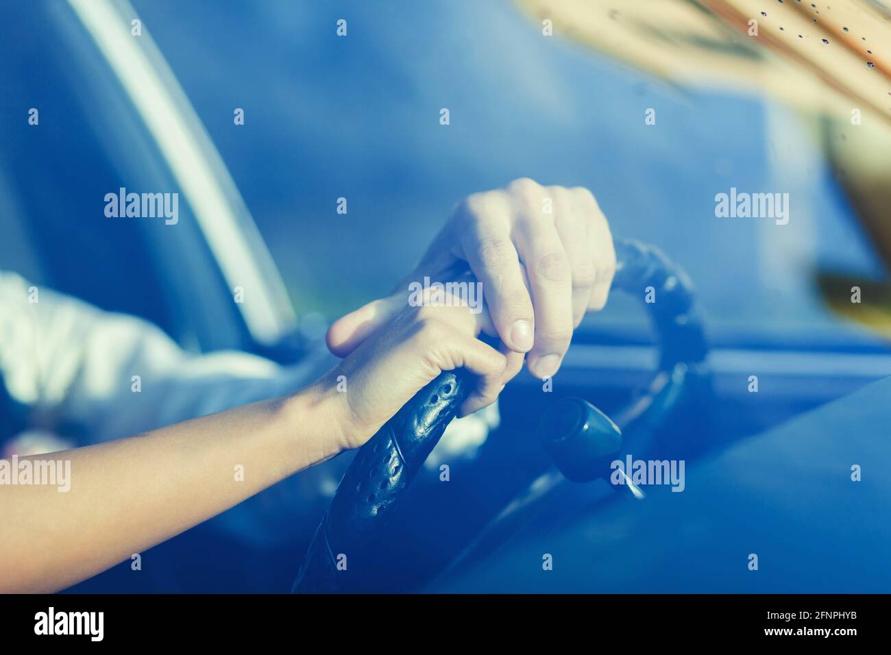 Bride's hand and the hand of the groom on car or automobile. True affection. Close up view. Stock Photo