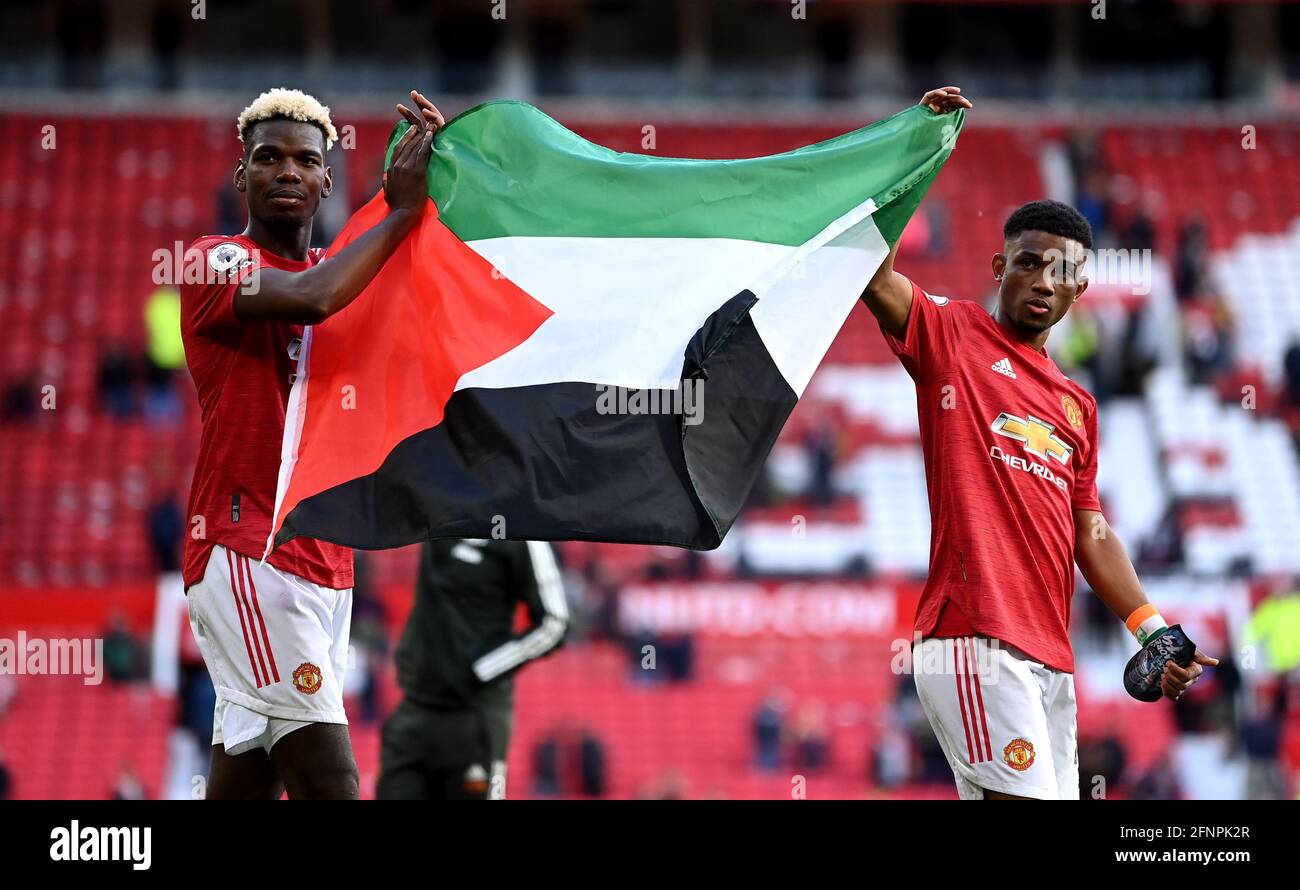 Manchester United's Paul Pogba (left) and Amad Diallo hold up the flag of Palestine after the Premier League match at Old Trafford, Manchester. Picture date: Tuesday May 18, 2021. Stock Photo