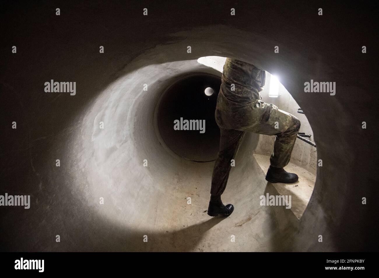 Calw, Germany. 10th May, 2021. A member of the German Armed Forces Special Forces Command (KSK) stands in a tube track facility of the German Armed Forces Special Forces Command (KSK), where, among other things, operations in tunnels are practiced. Credit: Marijan Murat/dpa/Alamy Live News Stock Photo