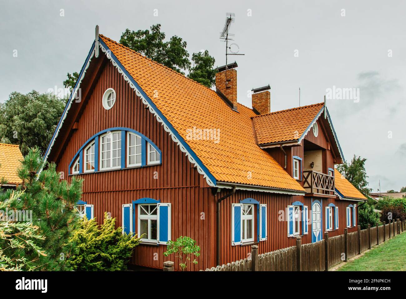 Nida,Lithuania- August 10,2019. Beautiful colorful traditional wooden architecture. Resort town on Curonian Spit. Typical fisherman's house Stock Photo