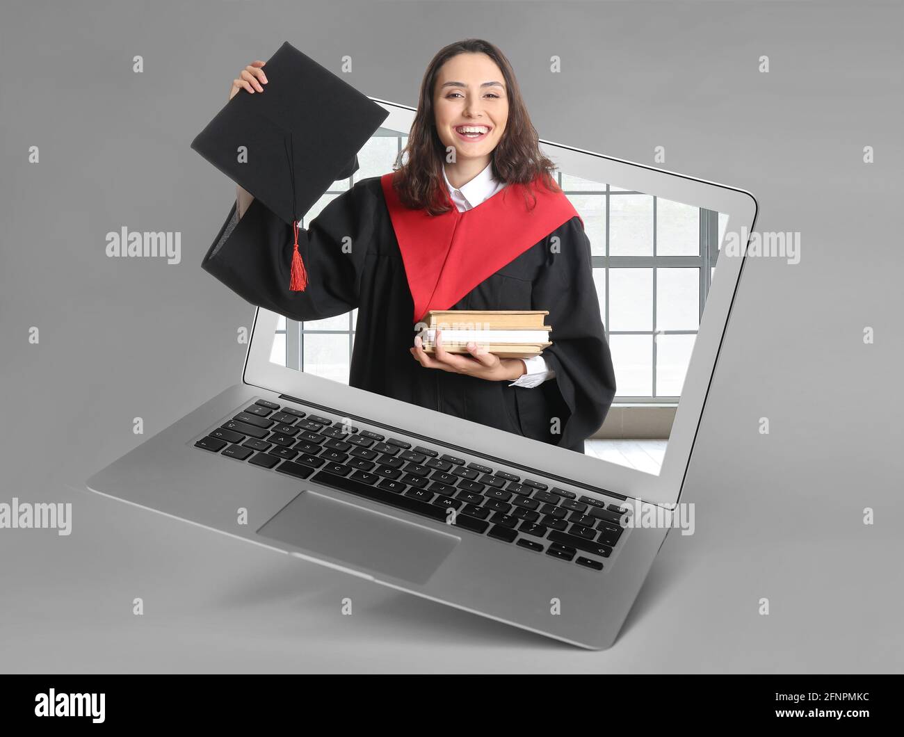 Female graduating student on screen of laptop against grey background ...