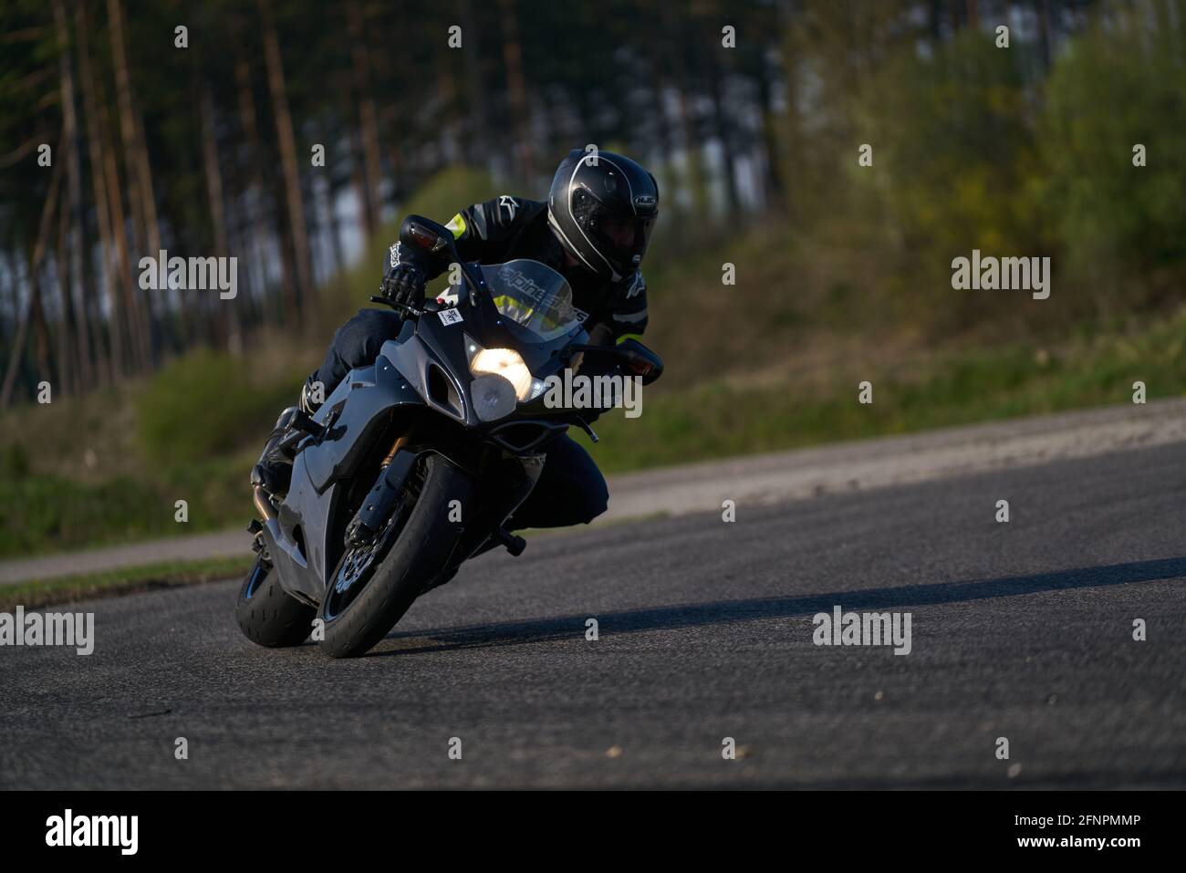 man riding motorcycle in asphalt road Stock Photo Alamy