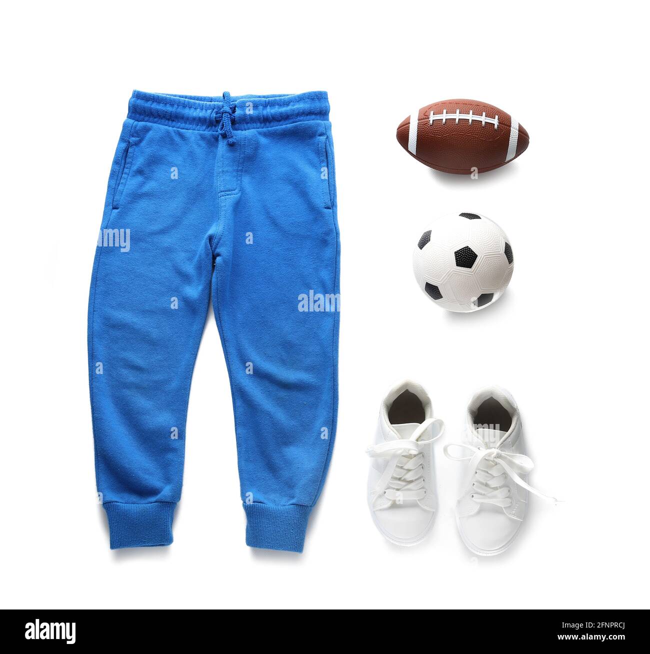 Set of child's clothes and balls on white background Stock Photo Alamy