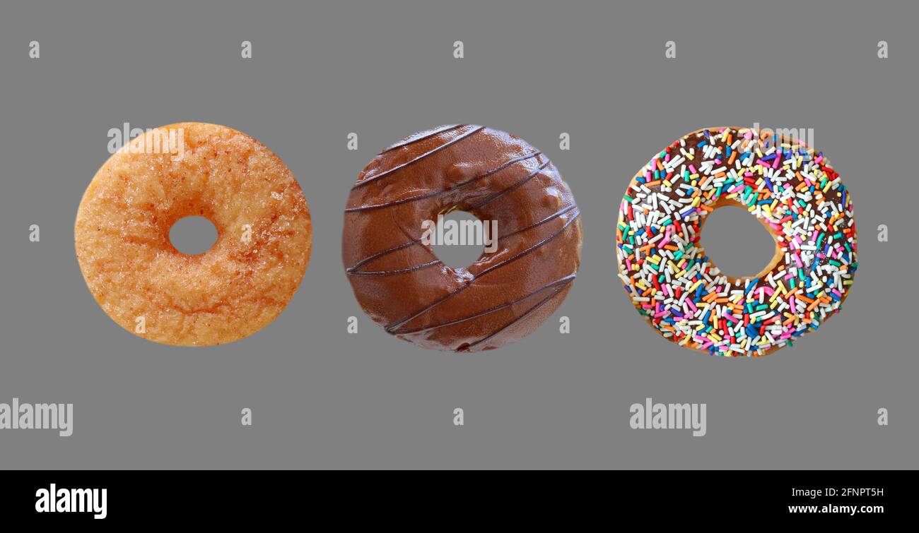 Three of Delectable Assorted Donuts Isolated on Gray Background Stock Photo
