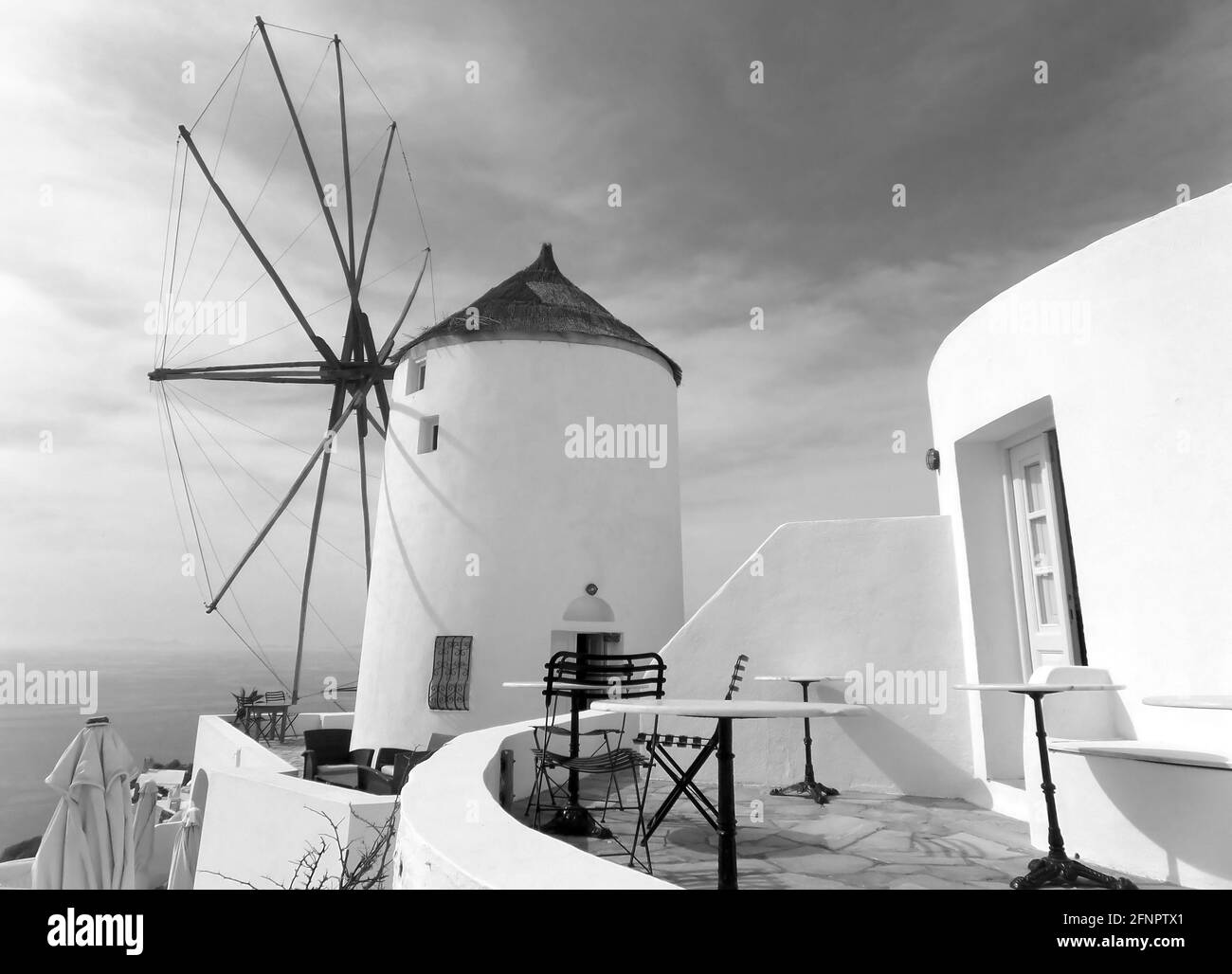 Monochrome Image of Greek Traditional Windmill at Oia Village on Santorini Island, Greece Stock Photo
