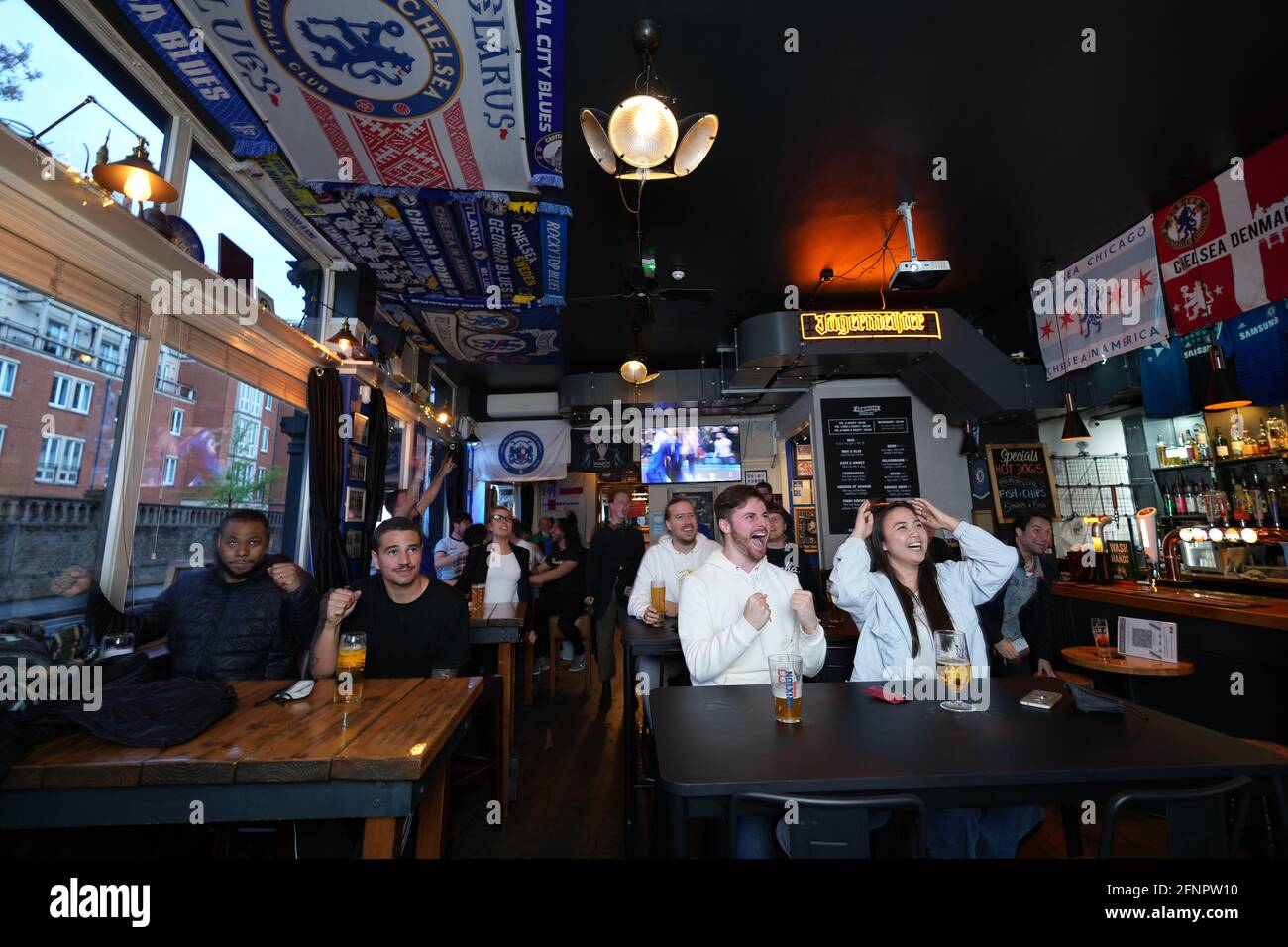 Chelsea fans in the Chelsea Pensioner Pub react as they watch the Premier  League match between Chelsea and Leicester City at Stamford Bridge, London.  Picture date: Tuesday May 18, 2021 Stock Photo - Alamy