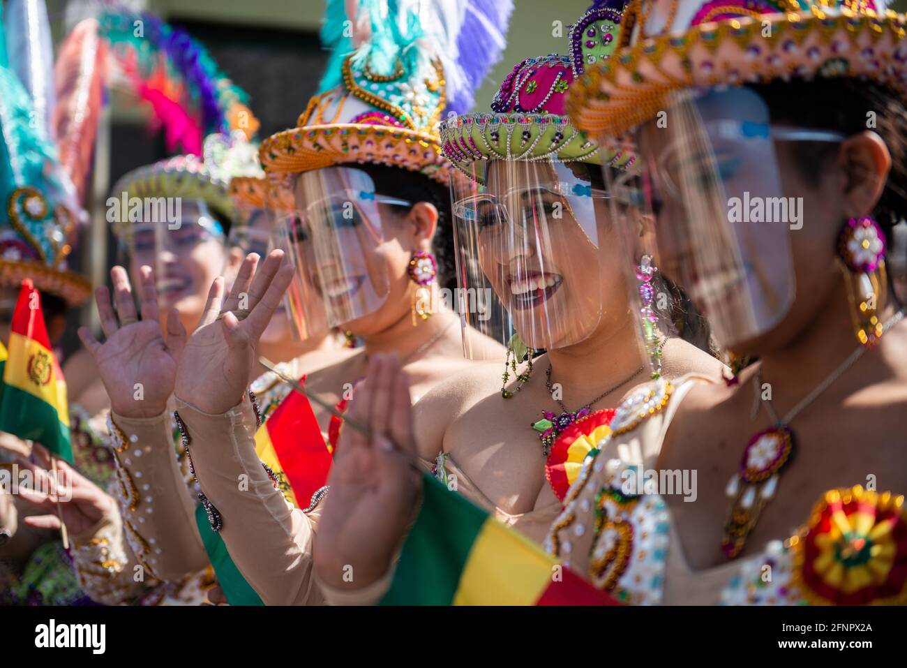 La Paz, Bolivia. 18th May, 2021. Women in traditional dress wave flags