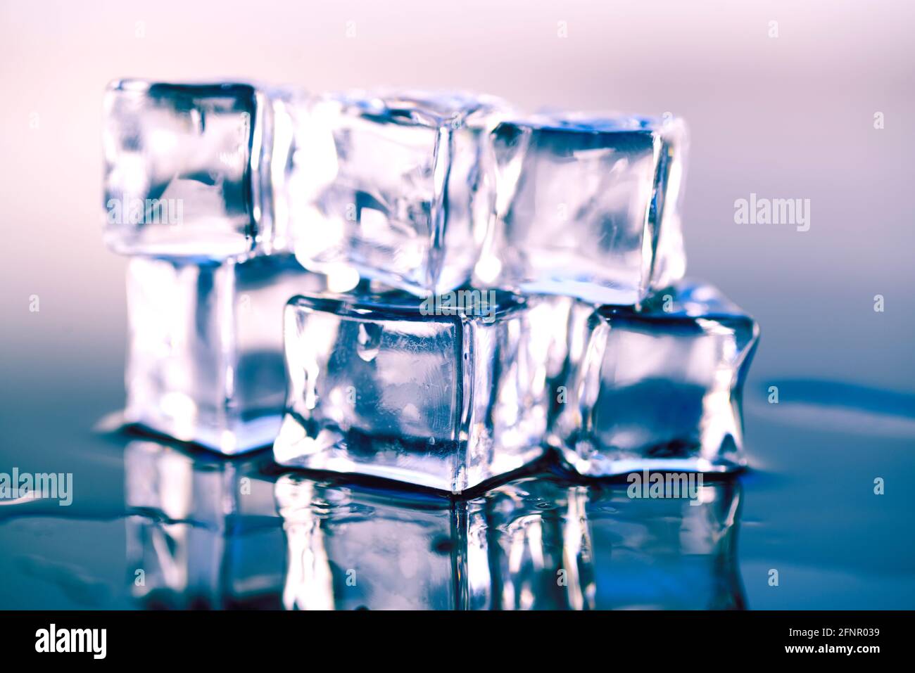 Wet ice cubes on gray background, close up Stock Photo