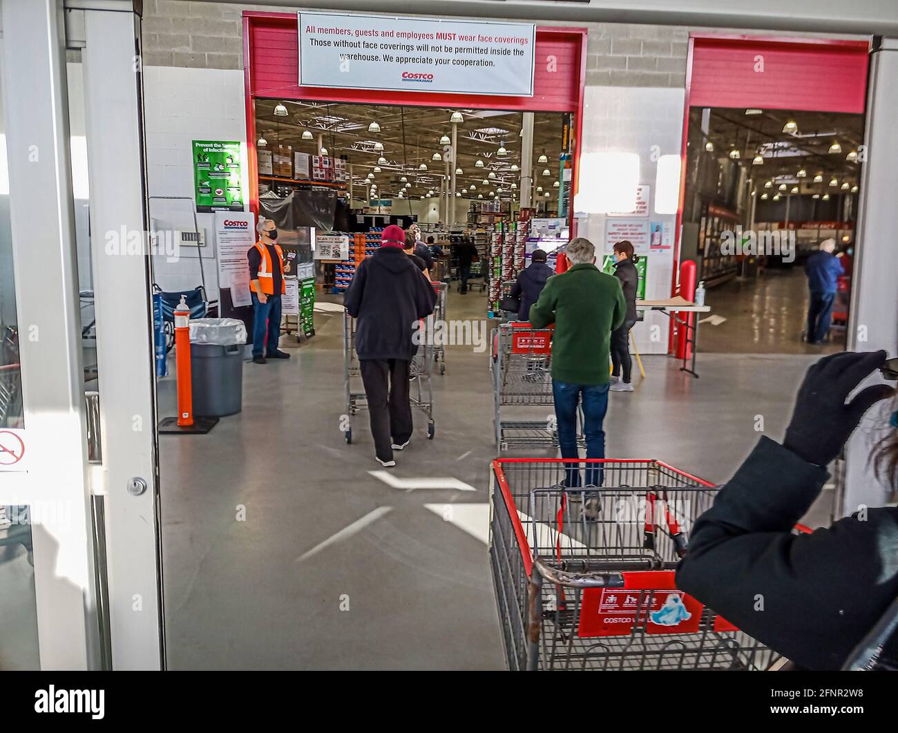 Toronto, Canada, May 2021 Customers social distancing while entering
