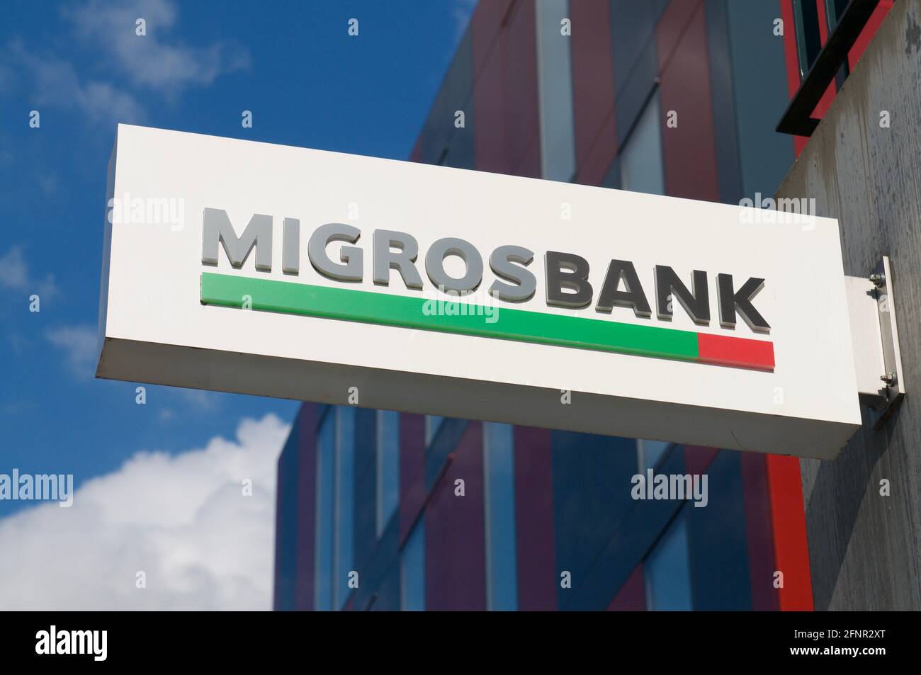 Wohlen, Aargau, Switzerland - 15th April 2021 : Migros Bank sign hanging on the building in the city of Wohlen, Switzerland Stock Photo