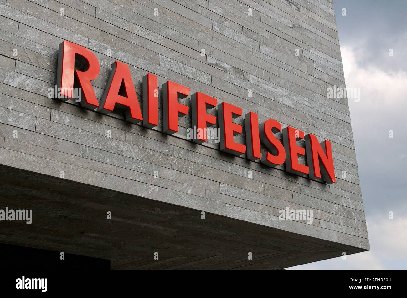 Wohlen, Aargau, Switzerland - 15th April 2021 : Swiss Raiffeisen bank sign on a concrete facade in Wohlen. Raiffeisen is a Swiss cooperative bank, the Stock Photo