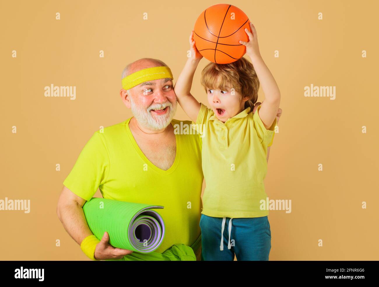 Healthy lifestyle. Grandfather and Grandson sporting. Basketball. Sport for kids. Happy family. Stock Photo