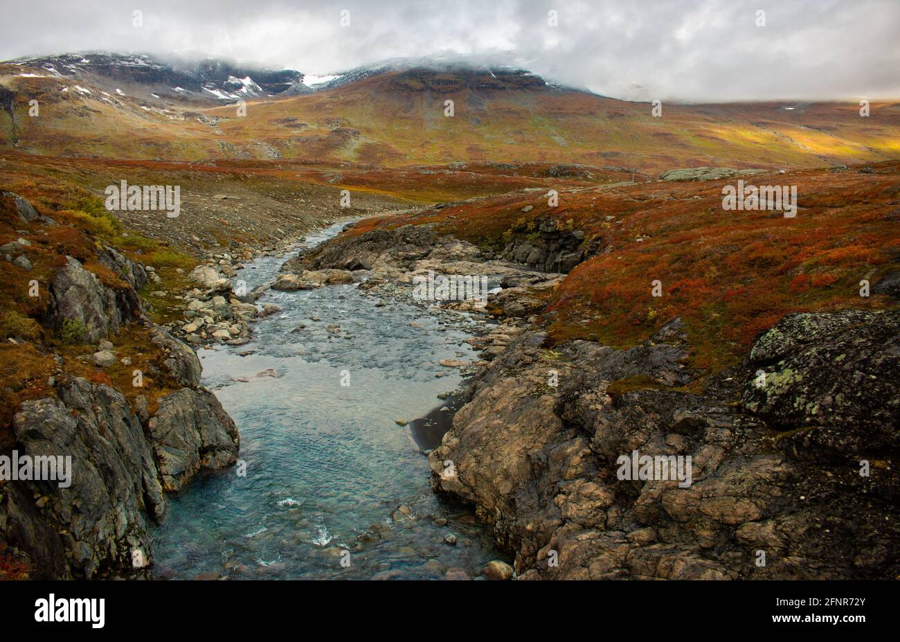 Sunrise at one of the streams crossing Kungsleden trail in September, close to Alesjaure, Swedish Lapland. Stock Photo