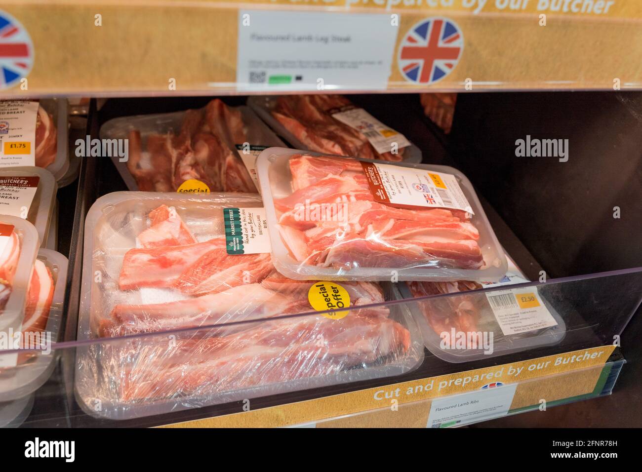 britsh lamb ribs prepacked in cling film on shelves for sale at