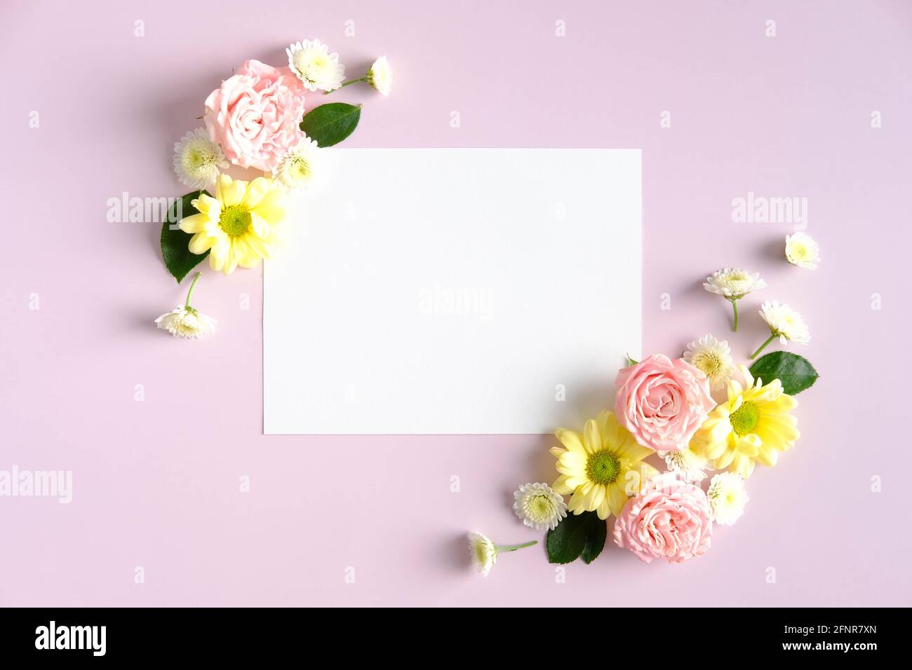 Blank paper card mockup and flowers on pink background. Happy Mother's