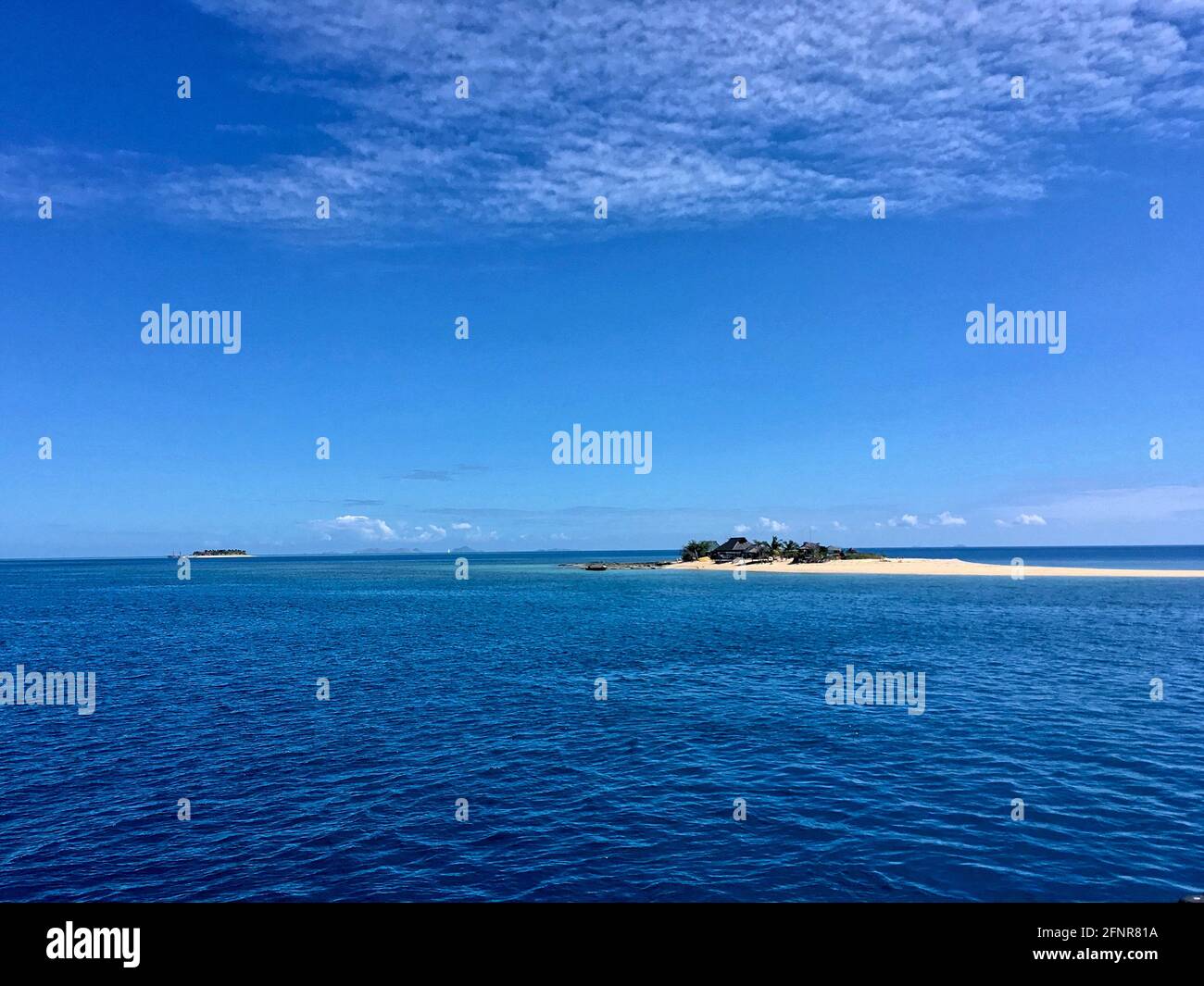 Small Fijian Island Covered In White Sand Surrounded By Ocean Stock Photo