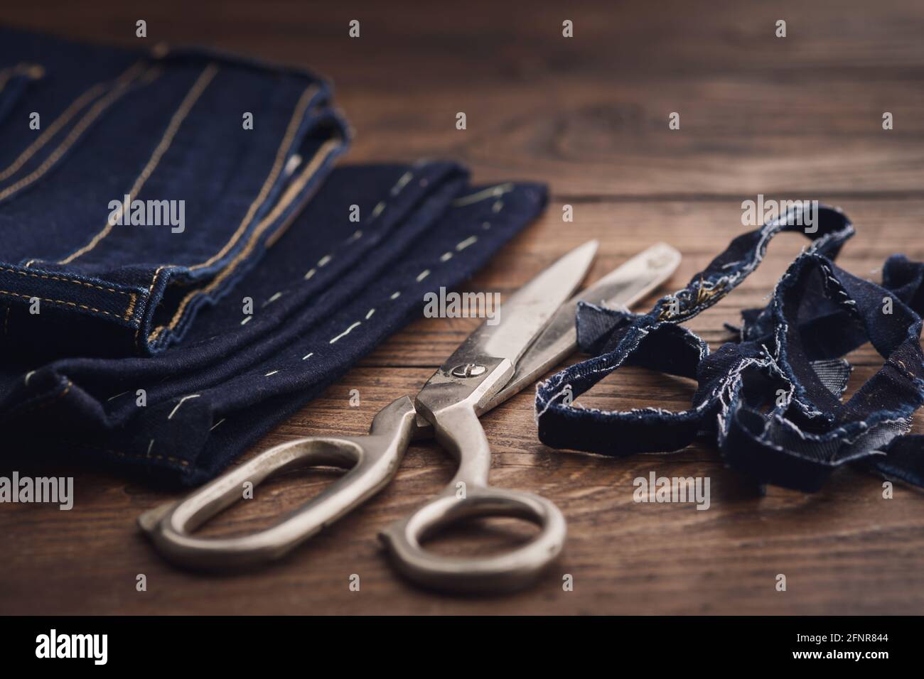 Shortening jeans pants. Jeans cutting Stock Photo Alamy