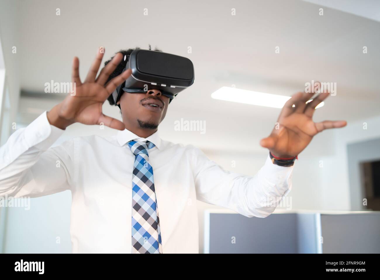 Afro Businessman using VR glasses Stock Photo - Alamy