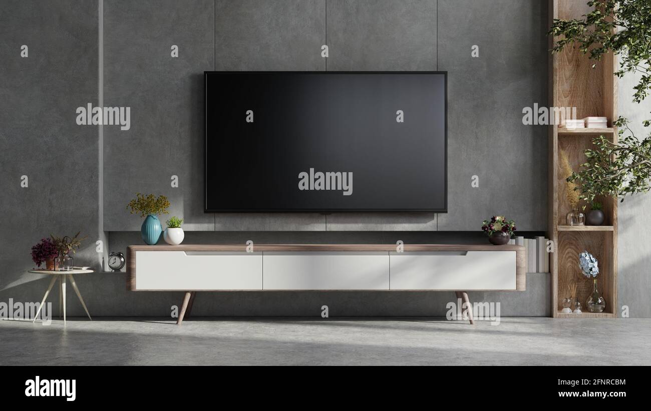Mockup a TV wall mounted in a dark room with concrete wall.3d rendering